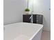 Close up of a bright bathroom featuring a soaking tub and stylish vanity at 221 Cosmopolitan Ct, Sarasota, FL 34236