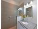 A well-lit bathroom boasts tile accents, a glass-enclosed shower, and modern fixtures for a spa-like retreat at 221 Cosmopolitan Ct, Sarasota, FL 34236