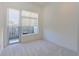 Bright bedroom with large windows and neutral carpet flooring provides a serene and comfortable living space at 221 Cosmopolitan Ct, Sarasota, FL 34236