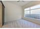 The bright bedroom features neutral tones, carpet flooring, and a modern sliding door for added privacy at 221 Cosmopolitan Ct, Sarasota, FL 34236