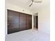 Bedroom featuring carpet and a wall of large sliding closets at 221 Cosmopolitan Ct, Sarasota, FL 34236