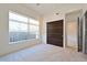 Bright bedroom featuring neutral decor, a large window with natural light, and convenient closet space at 221 Cosmopolitan Ct, Sarasota, FL 34236