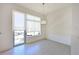 Bright dining area with tile floors, large windows and an elegant chandelier at 221 Cosmopolitan Ct, Sarasota, FL 34236