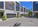 Modern townhome community with sleek design elements, contemporary windows and landscaped surroundings at 221 Cosmopolitan Ct, Sarasota, FL 34236