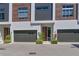 Modern townhome exterior featuring sleek design elements, contemporary windows, and a well-manicured landscape at 221 Cosmopolitan Ct, Sarasota, FL 34236