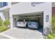 Spacious two-car garage with ample room for parking and storage, featuring clean lines and modern lighting at 221 Cosmopolitan Ct, Sarasota, FL 34236