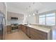 Modern kitchen with a stainless steel oven and dishwasher, light-colored cabinetry and a ceiling fan at 221 Cosmopolitan Ct, Sarasota, FL 34236