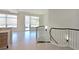 Bright living room with tile floors, large windows, and a curved staircase with modern metal railings at 221 Cosmopolitan Ct, Sarasota, FL 34236