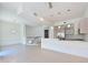 Expansive living area with neutral tile flooring, a modern kitchen and a staircase at 221 Cosmopolitan Ct, Sarasota, FL 34236