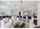 Open-concept living space with stylish furnishings, a modern kitchen, and staircase at 221 Cosmopolitan Ct, Sarasota, FL 34236