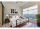 Comfortable main bedroom with a modern bed frame, natural light from large windows, and stylish decor at 221 Cosmopolitan Ct, Sarasota, FL 34236