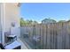 Cozy outdoor patio with glass railing and comfortable seating, perfect for relaxing and enjoying the view at 221 Cosmopolitan Ct, Sarasota, FL 34236