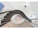 Dramatic spiral staircase with dark wood steps, stainless steel railings, and contemporary lighting at 221 Cosmopolitan Ct, Sarasota, FL 34236