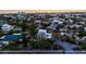 Sunset aerial view of a coastal neighborhood with houses, pools, and canals at 234 85Th St, Holmes Beach, FL 34217