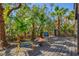 Charming back deck with fire pit surrounded by lush tropical foliage at 234 85Th St, Holmes Beach, FL 34217