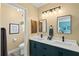 Stylish bathroom with dual sinks, modern fixtures, and a separate toilet area for added privacy at 234 85Th St, Holmes Beach, FL 34217