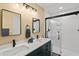 Well-lit bathroom with dual sinks, a walk-in shower, modern finishes, and ample space at 234 85Th St, Holmes Beach, FL 34217