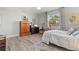 Comfortable bedroom with wood floors, ceiling fan, and natural light from the large window at 234 85Th St, Holmes Beach, FL 34217