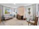 Well-lit bedroom with comfortable seating, Murphy bed, and views from multiple windows at 234 85Th St, Holmes Beach, FL 34217