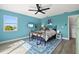 Comfortable bedroom with a ceiling fan, streaming television, and a serene atmosphere for relaxation at 234 85Th St, Holmes Beach, FL 34217