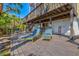 Outdoor deck with blue-and-yellow lawn chairs, an outdoor bar, and access to the backyard at 234 85Th St, Holmes Beach, FL 34217