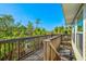 Wooden walkway surrounded by lush trees, offering a blend of privacy and nature at 234 85Th St, Holmes Beach, FL 34217