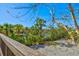 Overlooking a canal, a wood railing deck provides stunning views of water and lush foliage at 234 85Th St, Holmes Beach, FL 34217