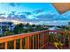 Scenic deck view showcasing waterfront homes, a serene canal, and clear blue skies at 234 85Th St, Holmes Beach, FL 34217