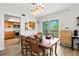 Dining area featuring stylish lighting, views into the kitchen, and sliding glass doors to the exterior at 234 85Th St, Holmes Beach, FL 34217