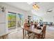 Dining room with an open floorplan and natural light from a sliding glass door leading to the outside deck at 234 85Th St, Holmes Beach, FL 34217