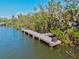 Picturesque waterfront dock providing access to serene waters and lush greenery at 234 85Th St, Holmes Beach, FL 34217