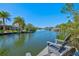 Waterfront with private dock, seating, and tropical landscaping at 234 85Th St, Holmes Beach, FL 34217