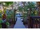 Private dock leading to waterfront with lush tropical surroundings at 234 85Th St, Holmes Beach, FL 34217