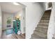 Bright entryway with wood-look floors, a unique storage cabinet, and a staircase leading to the upper level at 234 85Th St, Holmes Beach, FL 34217