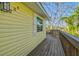 View of a charming yellow home featuring an outdoor wooden walkway at 234 85Th St, Holmes Beach, FL 34217