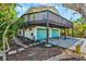 Home with multi-car garage, back deck, and tropical landscaping at 234 85Th St, Holmes Beach, FL 34217
