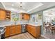 Traditional kitchen with stainless steel appliances, wood cabinets, tile backsplash, and a view to the dining room at 234 85Th St, Holmes Beach, FL 34217