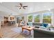 Inviting living room with an open floorplan and natural light from a sliding glass door leading to the outside deck at 234 85Th St, Holmes Beach, FL 34217