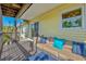 Outdoor porch offering comfortable seating and a view of lush foliage at 234 85Th St, Holmes Beach, FL 34217
