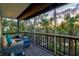 Relaxing screened porch features comfortable seating and views of lush tropical landscaping at 234 85Th St, Holmes Beach, FL 34217