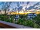 Scenic sunset view overlooking waterfront properties and lush greenery from the porch at 234 85Th St, Holmes Beach, FL 34217