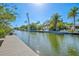 Stunning waterfront property featuring lush tropical landscaping and a private dock at 234 85Th St, Holmes Beach, FL 34217