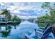 Scenic waterfront view from the private dock with relaxing seating, perfect for enjoying tranquil evenings at 234 85Th St, Holmes Beach, FL 34217