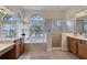 Bright bathroom with dual vanities, soaking tub, walk-in shower, and natural light at 24017 Peppercorn Rd, Punta Gorda, FL 33955