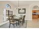 Bright dining room with modern light fixture, table with six chairs, and large window at 24017 Peppercorn Rd, Punta Gorda, FL 33955