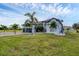 A beautiful two-story house with a well-manicured lawn and lush tropical landscaping at 24017 Peppercorn Rd, Punta Gorda, FL 33955