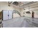 Large garage with ample storage, featuring stairs and a classic grandfather clock for unique charm at 24017 Peppercorn Rd, Punta Gorda, FL 33955