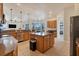 Open kitchen design with modern appliances, a kitchen island, and adjacent living spaces at 24017 Peppercorn Rd, Punta Gorda, FL 33955