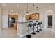 A spacious kitchen featuring a breakfast bar, pendant lighting, and stainless steel appliances at 24017 Peppercorn Rd, Punta Gorda, FL 33955
