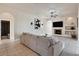 Cozy living space with an arched doorway, tile flooring, a fireplace, and a large television at 24017 Peppercorn Rd, Punta Gorda, FL 33955
